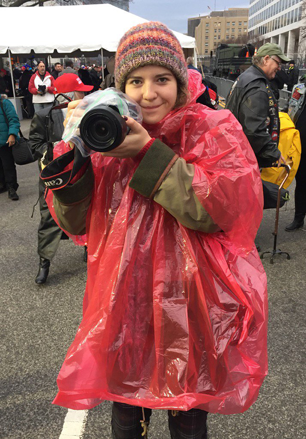 Student Robi Foli is poised with a camera in DC.