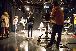 people filming on sound stage