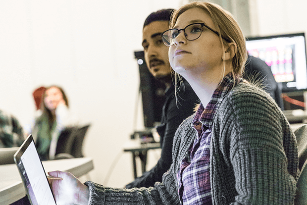 two people at computer in classroom looking up