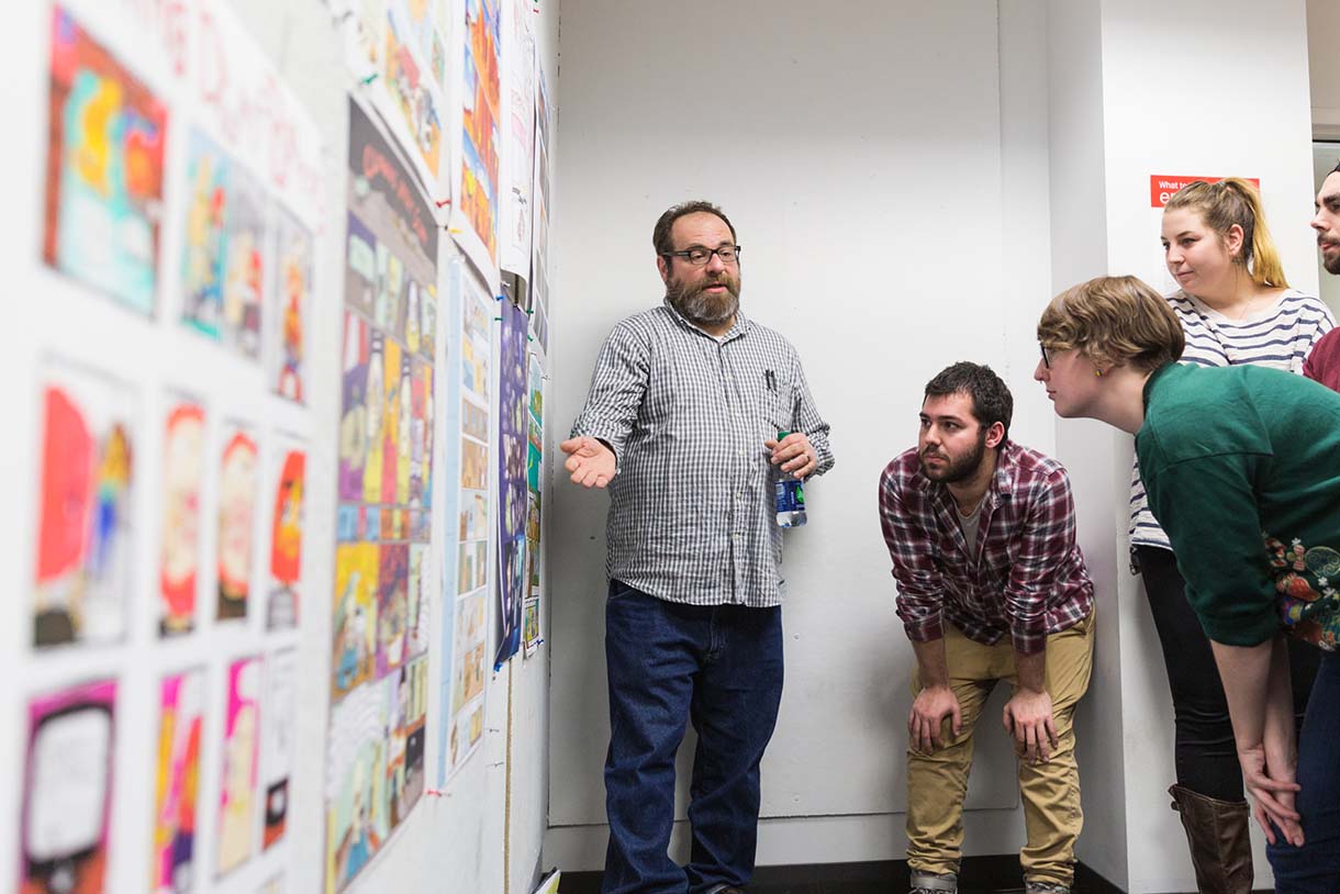 students looking at artwork on wall