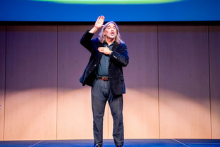 ASL Department Chair Peter Cook on stage at the Deaf Awareness Day event