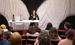 Martyna Majok sitting in a theater speaking to students. 