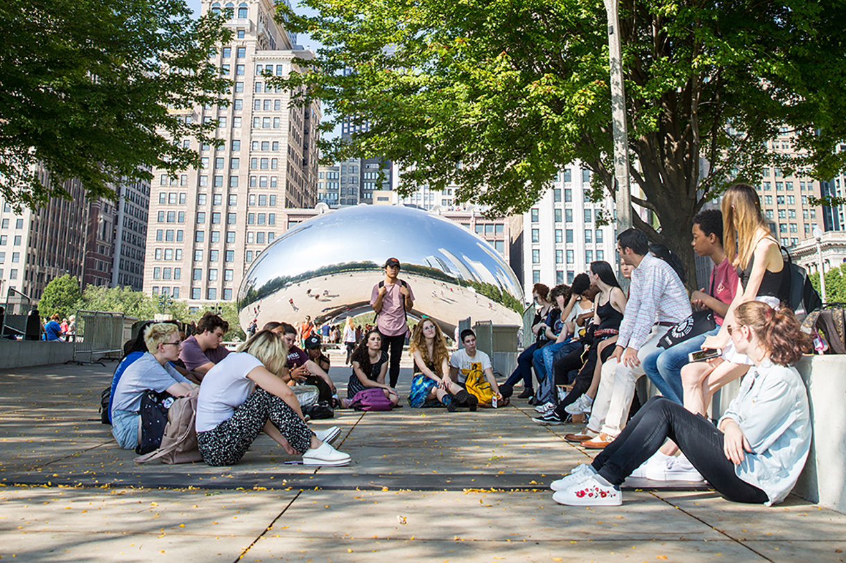 students sitting around CloudGate sculpture in Chicago