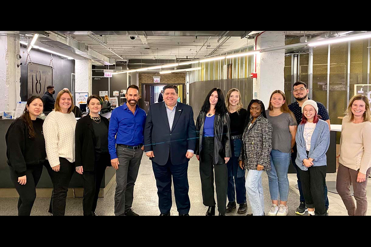 A group of Columbia students pose with Governor J.B. Pritzker