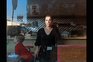 waitress and child behind a window at a restaurant