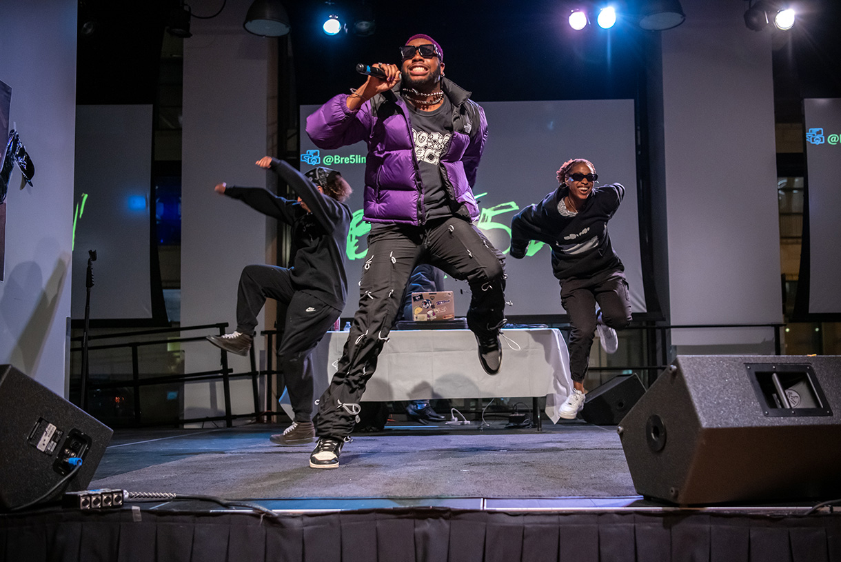MC and two dancers performing on stage