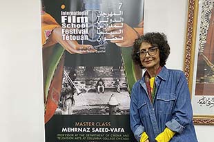 photo of Mehrnaz Saeed-Vafa in front of master class poster at film festival