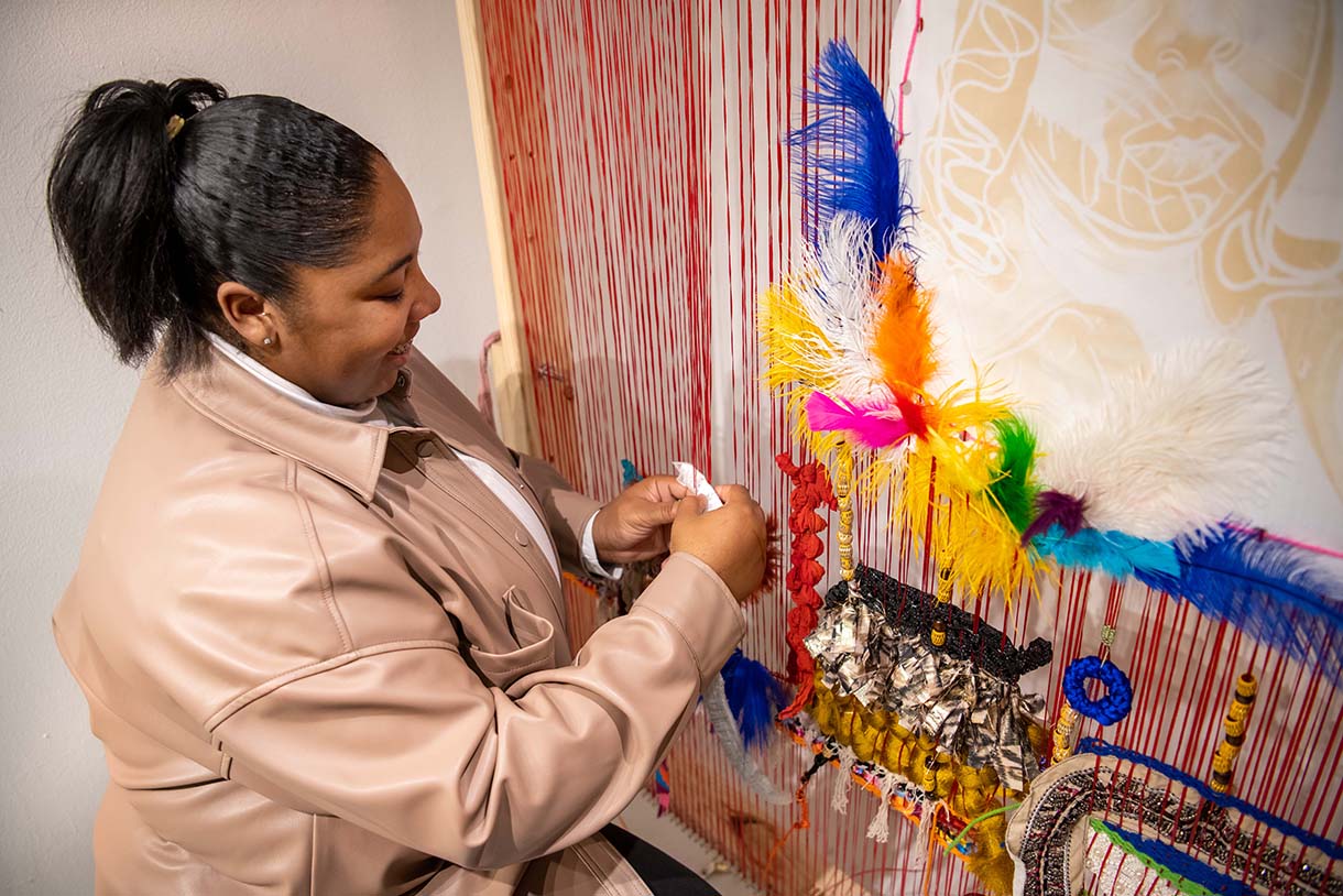 shaquita reed displays her woven art piece