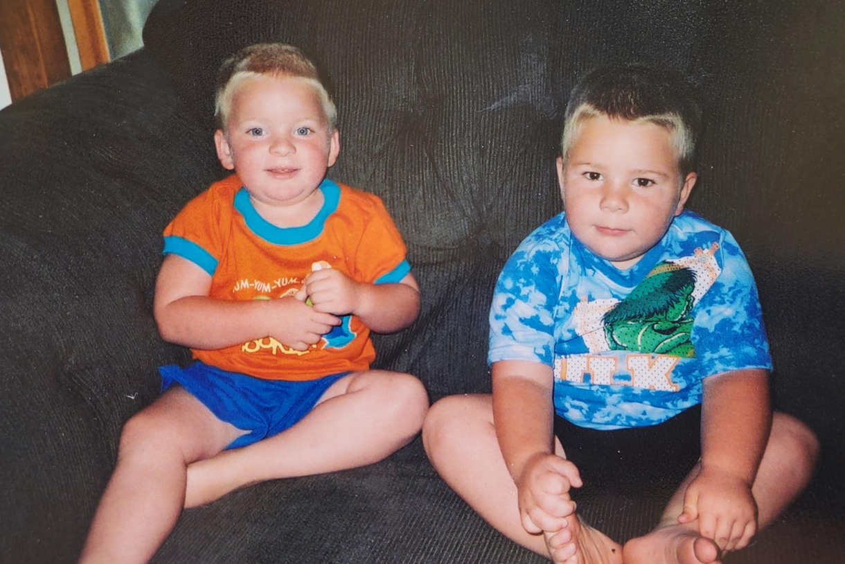 photo of the twins as young boys sitting on couch