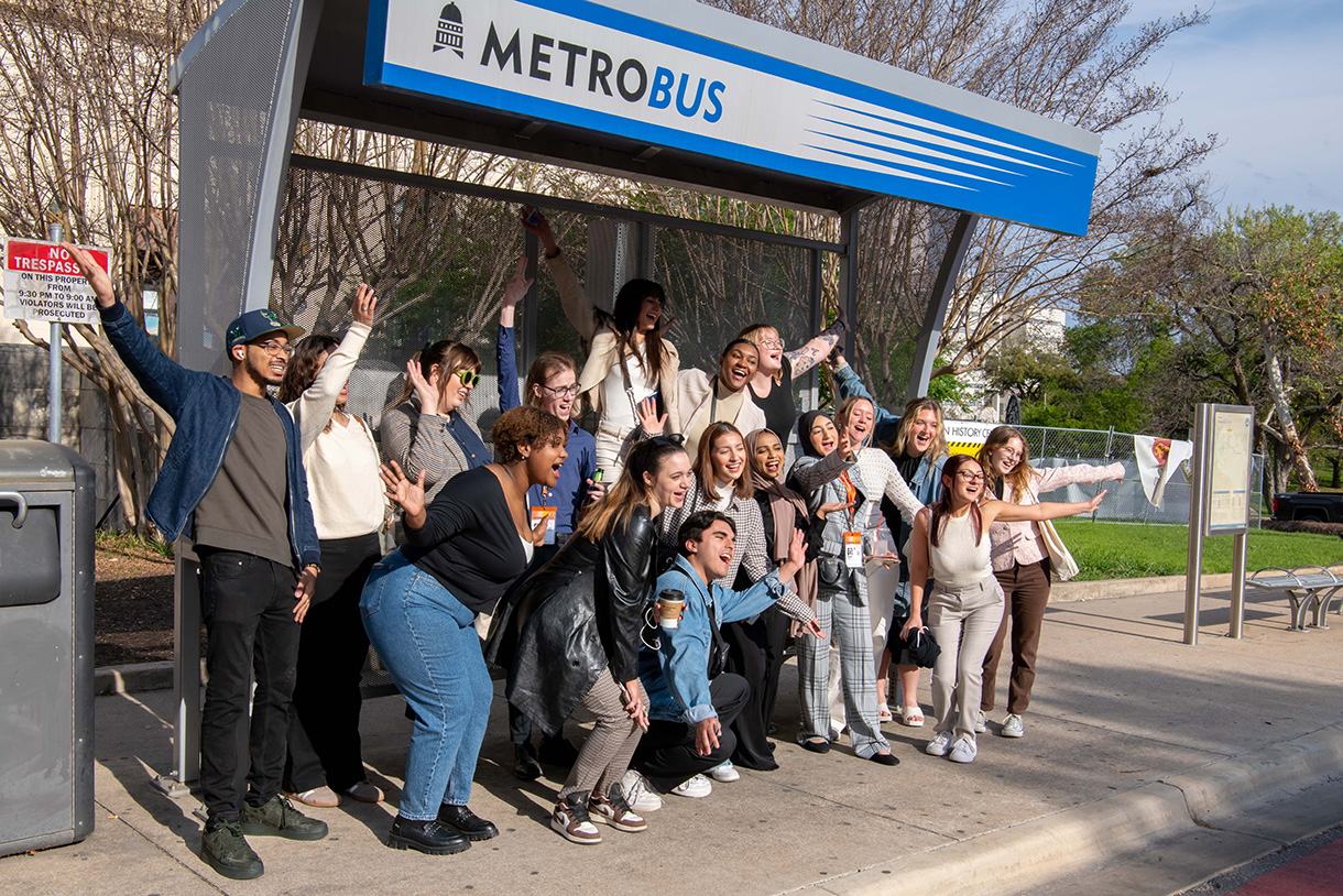 students pose at austin bus stop