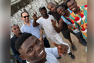 robert hanserd and Rami Gabrie with a group photo of individuals in Ghana