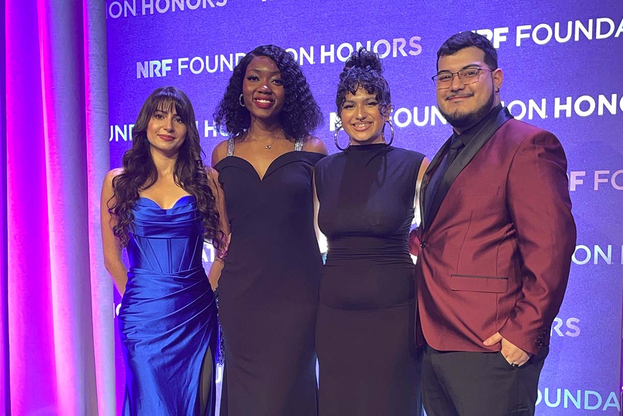 Ivonne Malagon, Aleesa Wright, Alexis Norris, and Juan Osorio pose together at honors event with nrf branding in background