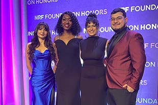 Ivonne Malagon, Aleesa Wright, Alexis Norris, and Juan Osorio pose together at honors event with nrf branding in background